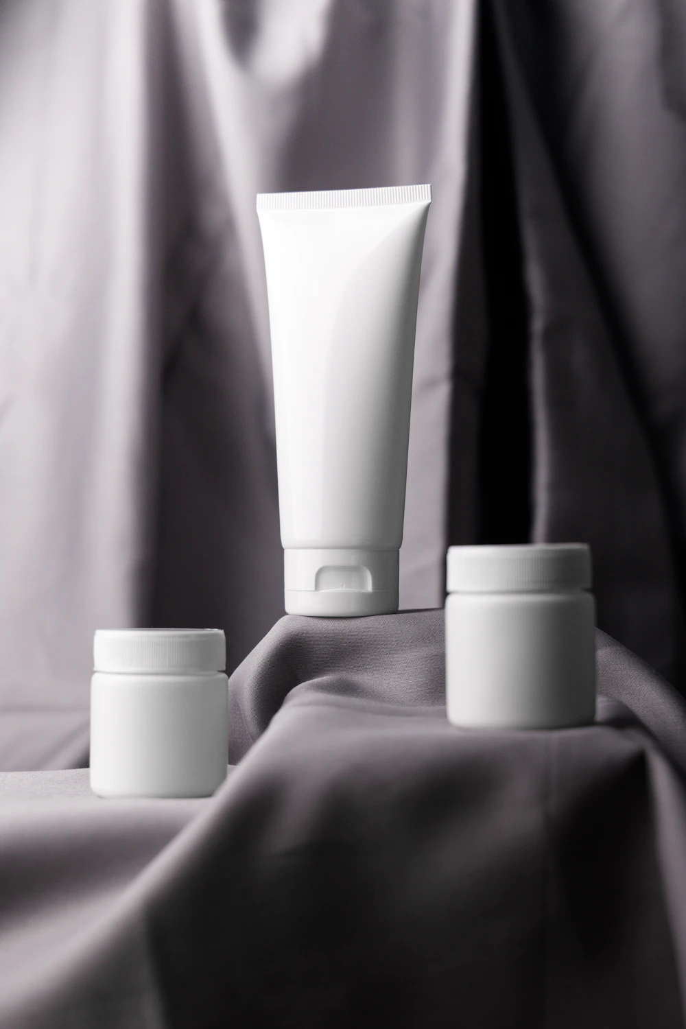Tubo e potes brancos de cosméticos